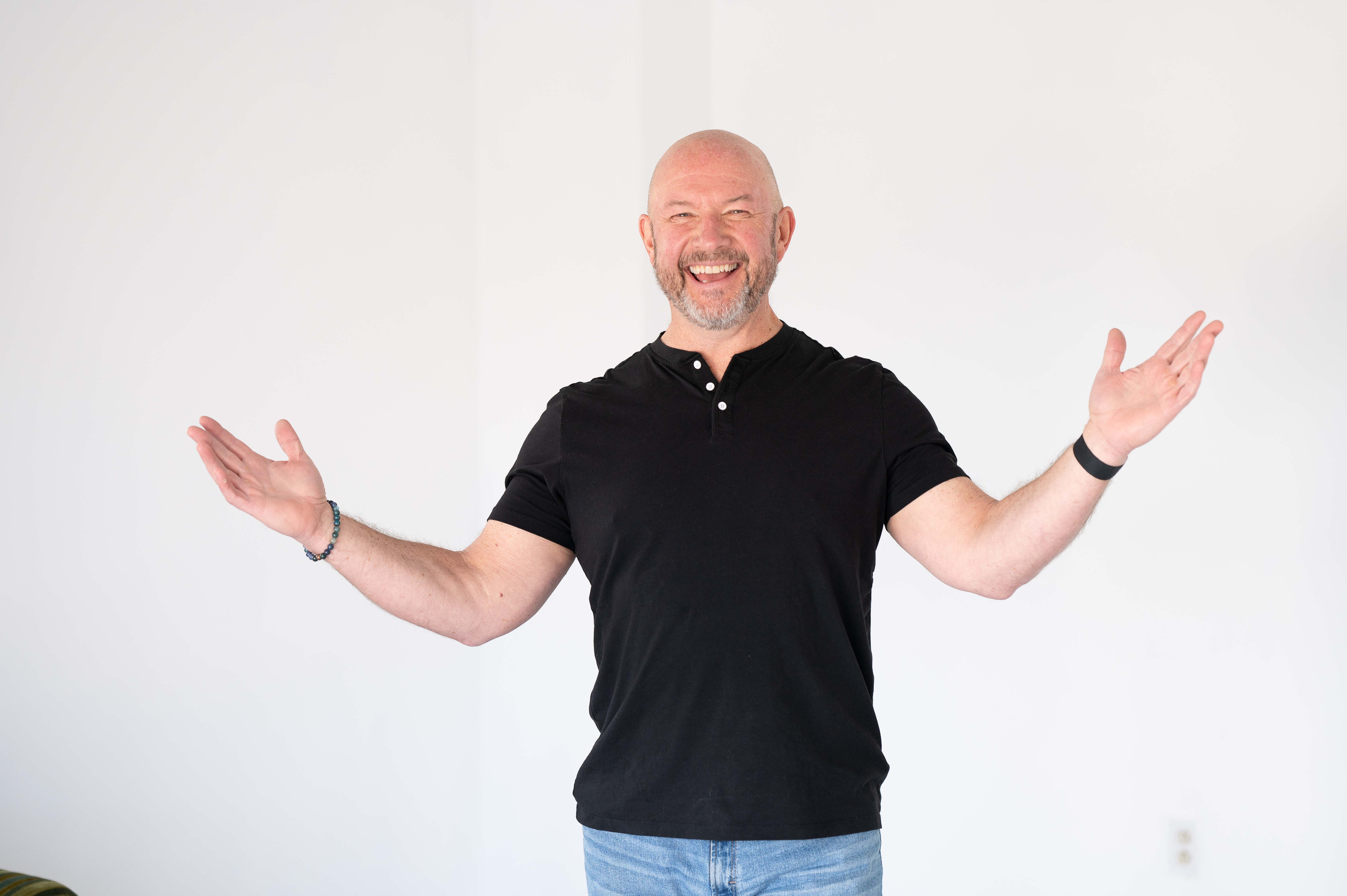 Mark Worster laughing, arms open